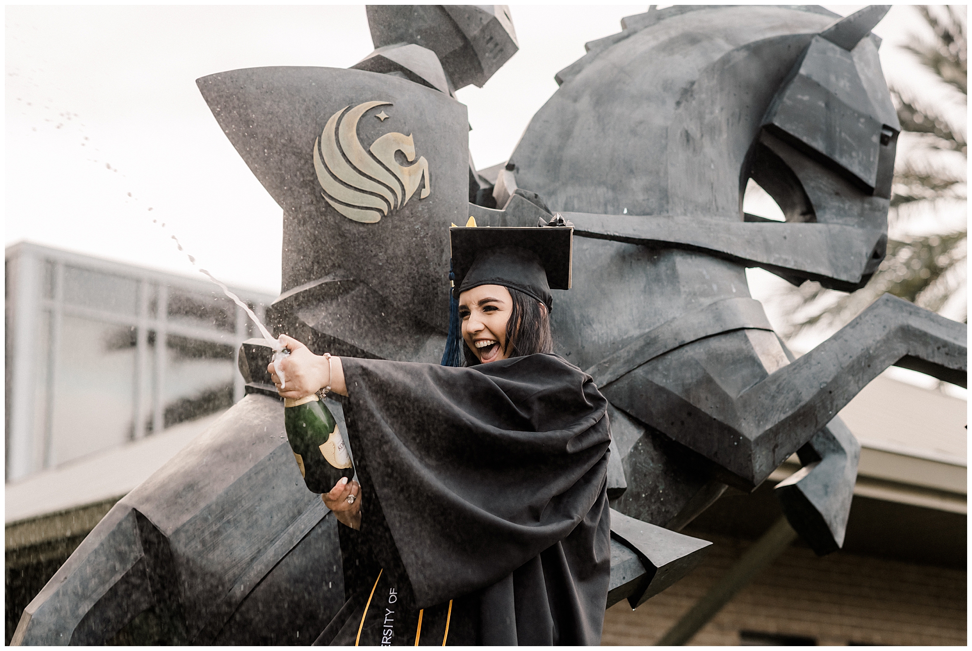 UCF Fall Graduation Session at the University of Central Florida | Haleigh Nicole Photography | UCF Graduation Photographer | This UCF fall graduation session featured shades of gold and black. The UCF graduate was an Elementary Education major and celebrated with champagne and confetti in the rain. #confettigraduate #champagnegraduate #ucfgraduation #ucf #classof2020 #ucfgraduationphotographer #orlandoportraitphotographer