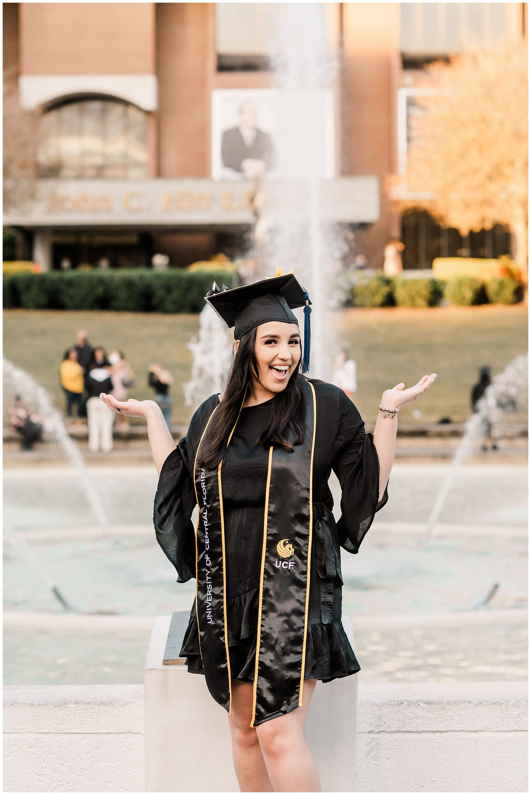 UCF Fall Graduation Session at the University of Central Florida | Haleigh Nicole Photography | UCF Graduation Photographer | This UCF fall graduation session featured shades of gold and black. The UCF graduate was an Elementary Education major and celebrated with champagne and confetti in the rain. #confettigraduate #champagnegraduate #ucfgraduation #ucf #classof2020 #ucfgraduationphotographer #orlandoportraitphotographer