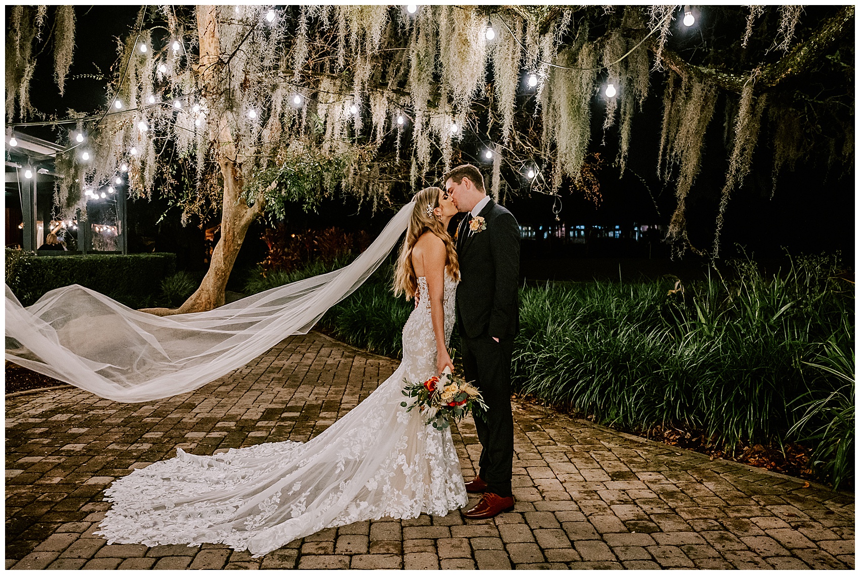 bride and groom kiss with flowing veil at Historic Dubsdread Ballroom wedding