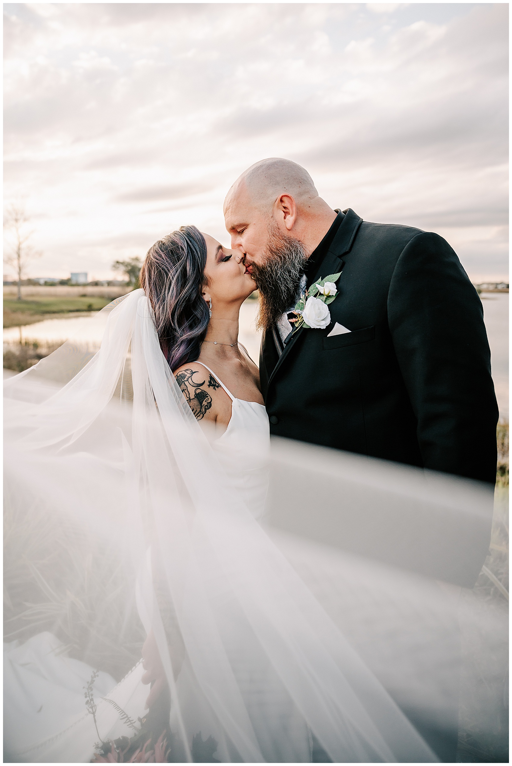 bride and groom kiss behind veil at Canvas Lake Nona Wedding