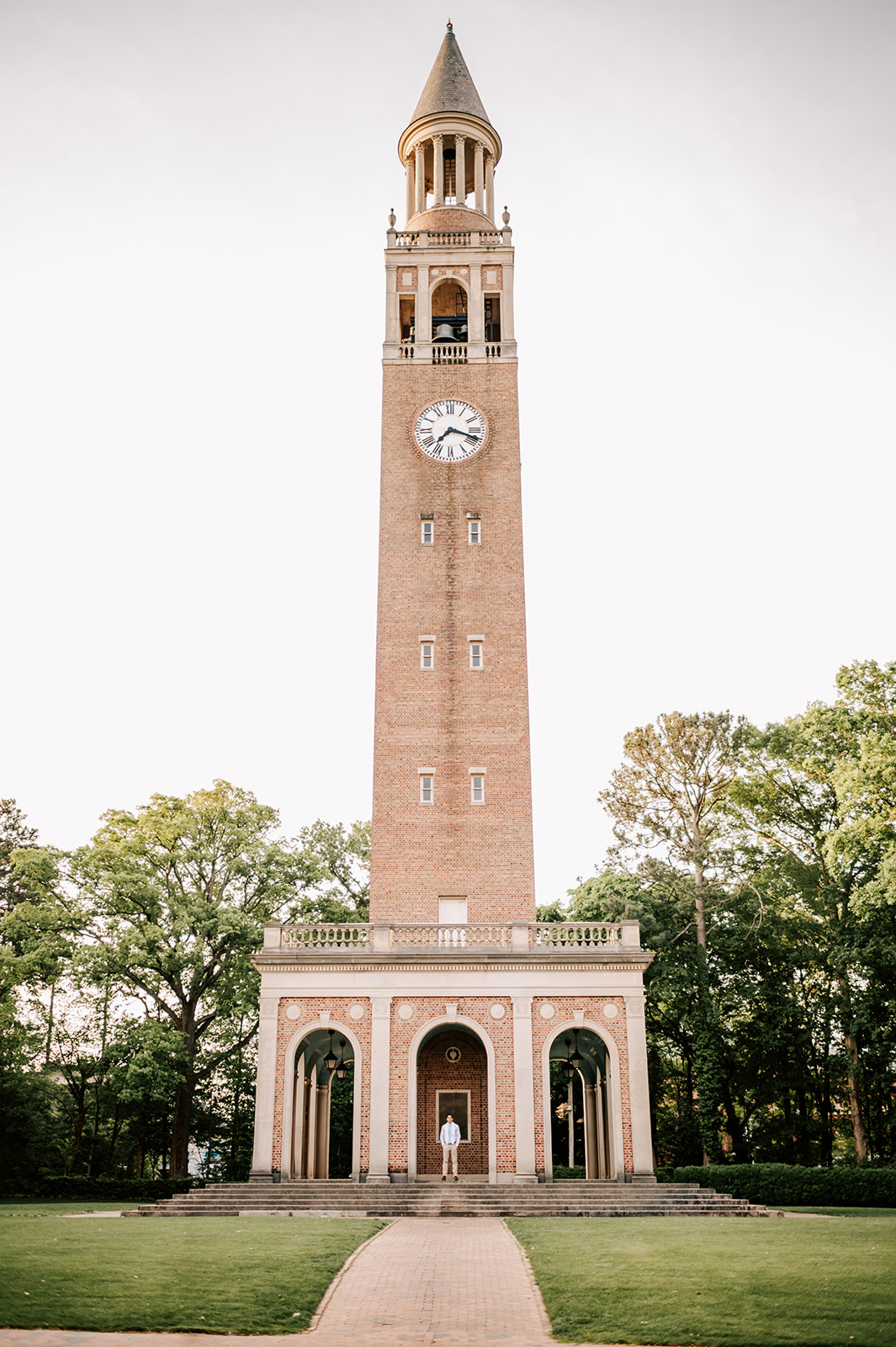 A look at the clock tower as one of the UNC-Chapel Hill Graduates stands at the base